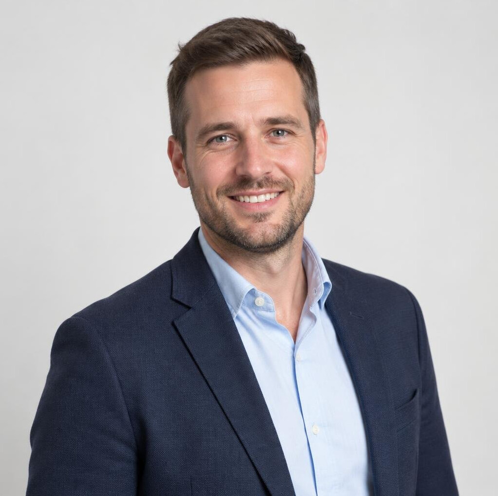 Studio portrait of a smiling Belgian businessman in his thirties